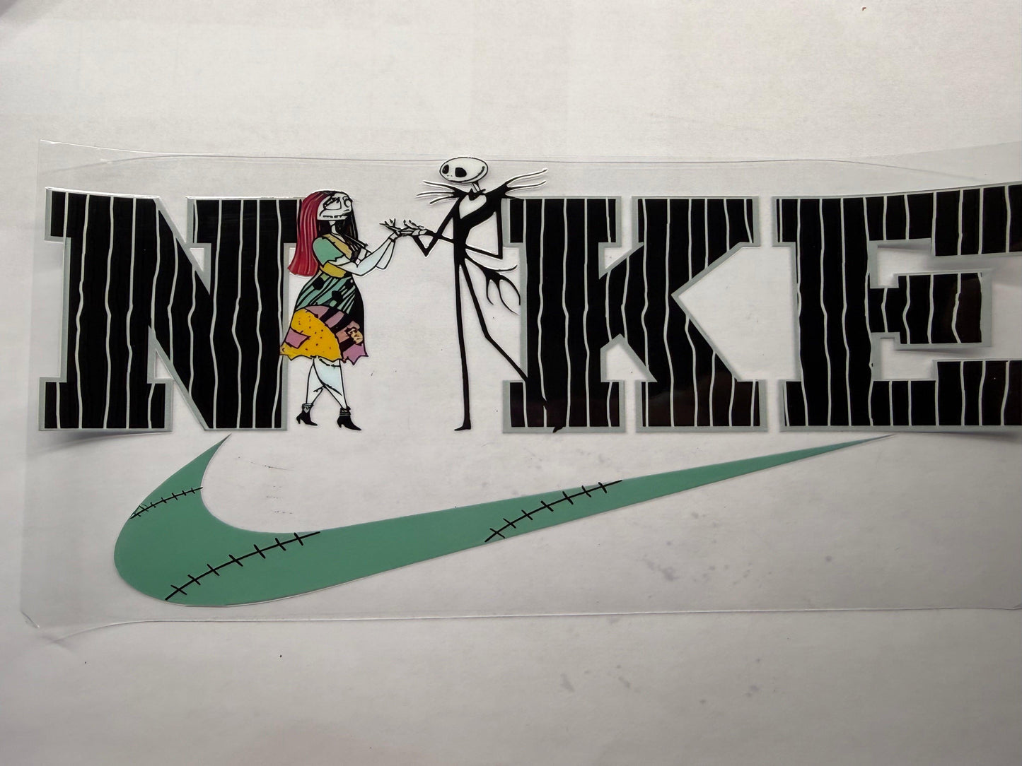 Nike logo with cartoon characters from 'The Nightmare Before Christmas' on a white background